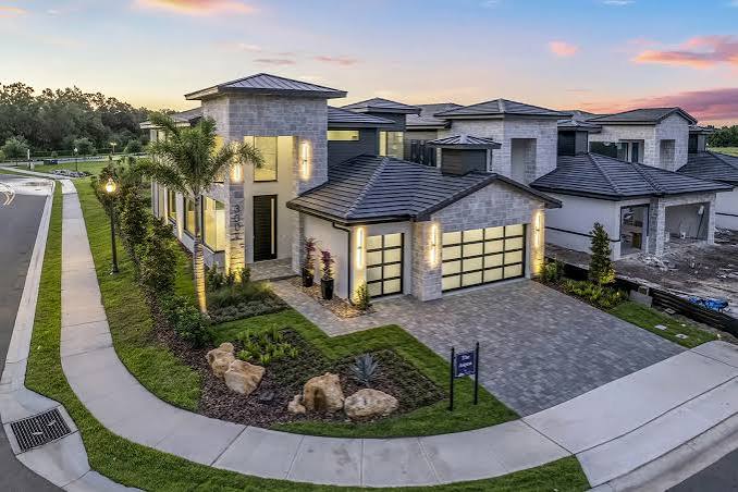 Aerial view of a new construction stone estate at dusk