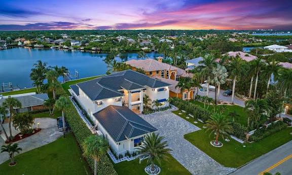 Aerial view of a waterfront estate with a private dock