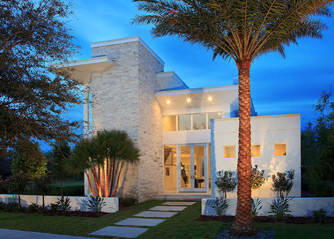 Modern stone estate home at dusk